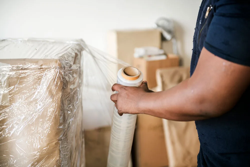 a person holding a roll of plastic